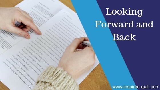A blog feature image showing someone editing an A4 page with a blue pen and the title 'Looking Forward and Back' over the top