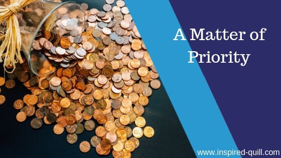 A blog feature image showing a glass jar of pennies spilled over a table with the title 'A Matter of Priority' over the top